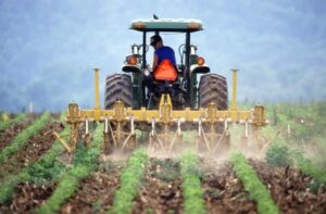 spring planting - farmer on tractor farmer insights